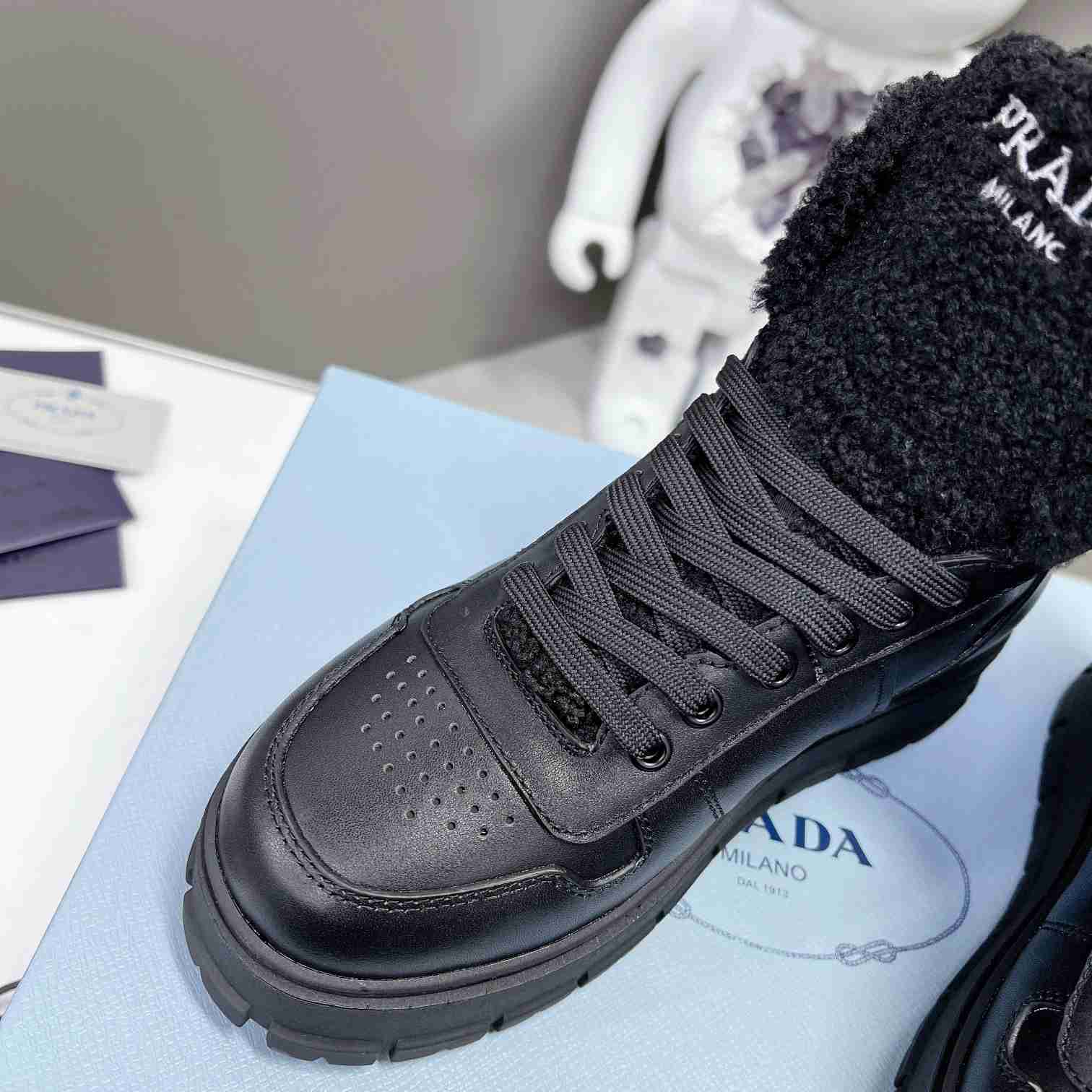 Prada Leather And Shearling High-top Sneakers - DopestKickz