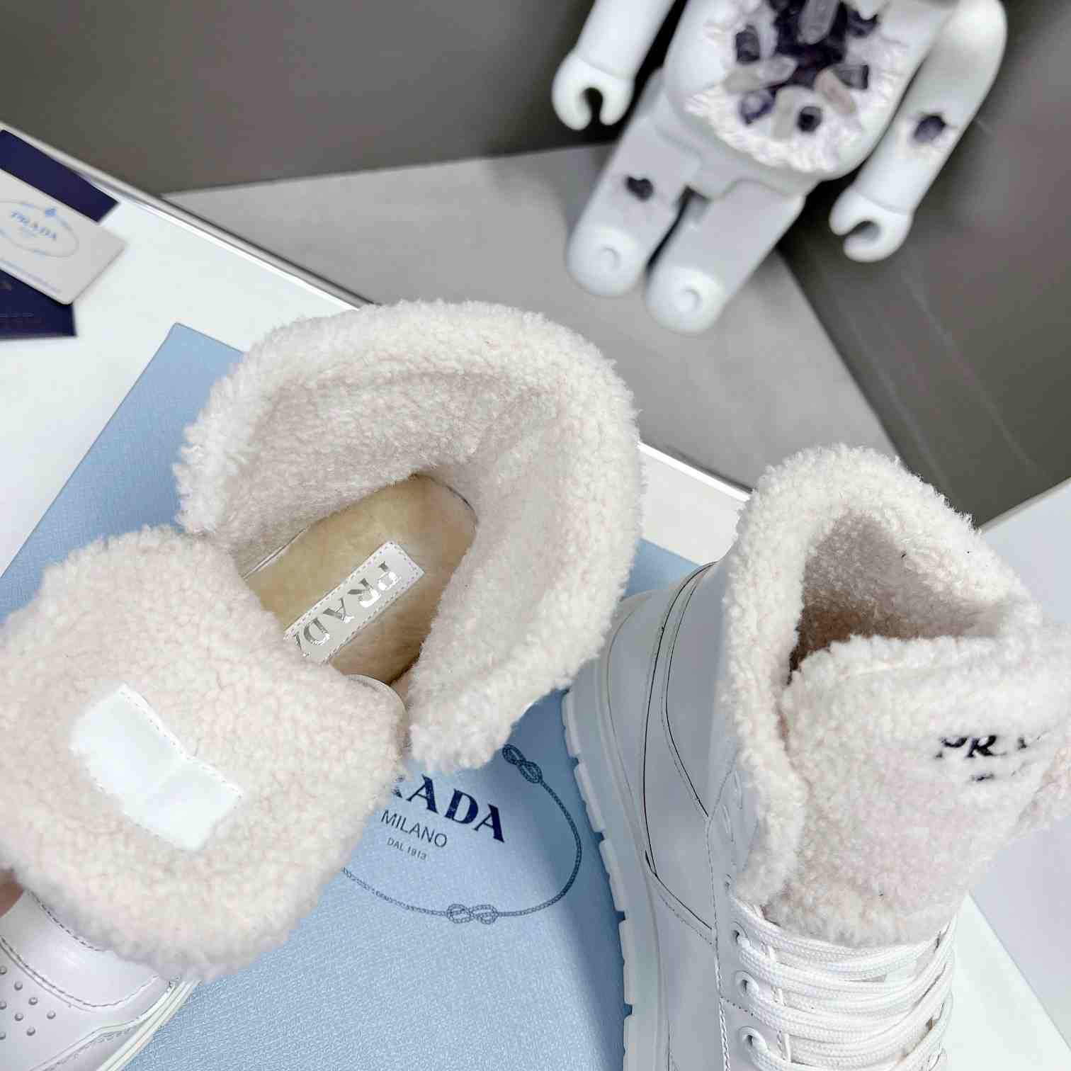 Prada Leather And Shearling High-top Sneakers - DopestKickz